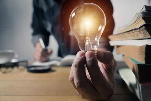 Hand holding a light bulb. Innovation and creative concept.