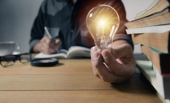 Hand holding a light bulb. Innovation and creative concept.