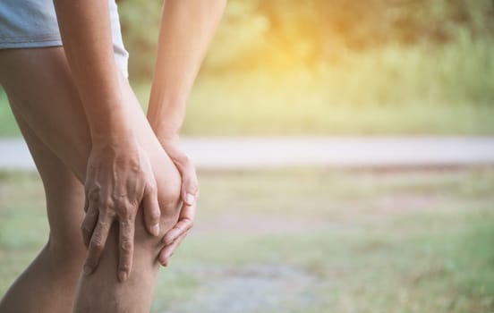 The female clings to a bad leg. The pain in her leg. Healthcare and painful concept.