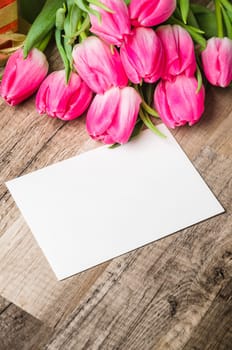 Beautiful bouquet of pink tulips and congratulations on the table