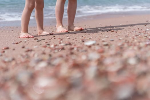 Little boy and girl standing on the beach in summer