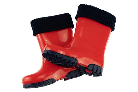 Children shoes and boots. Closeup of a pair red rubber boots isolated on a white background. Kids shoes fashion.