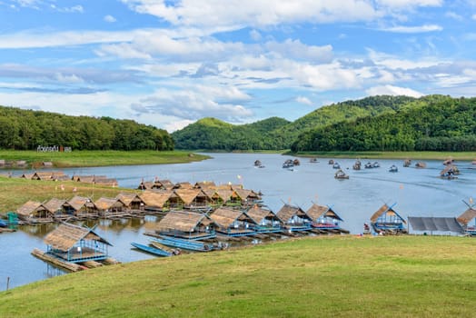 Beautiful natural landscape of the river, mountain, blue sky, green forest and bamboo raft shelter is part of the floating restaurant at Huai Krathing is a tourist attraction of Loei province, Thailand