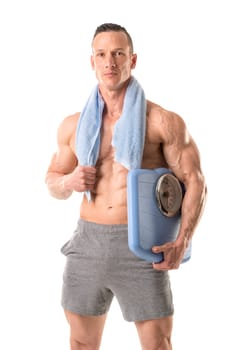 Powerful athletic man with great physique holding a weight scale isolated in a white background