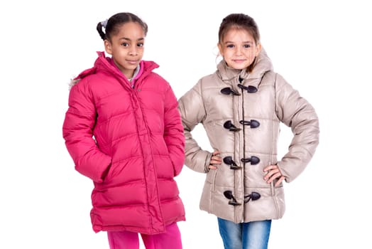 Young girls posing in winter coats isolated in white