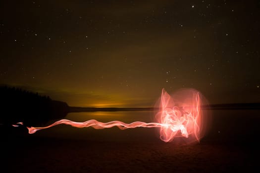 Light Painting by Lake with stars and clouds.