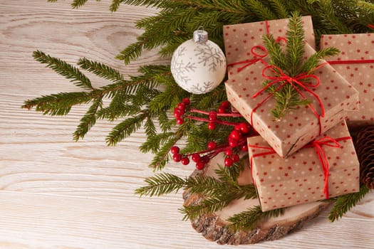 Still life with gift boxes, fir tree branches and christmas decorations on a wooden background.Top view. Christmas and New Year