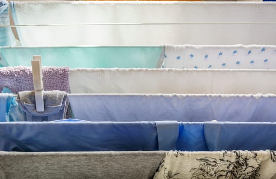 Laundry on a clothesline drying with a white plastic peg