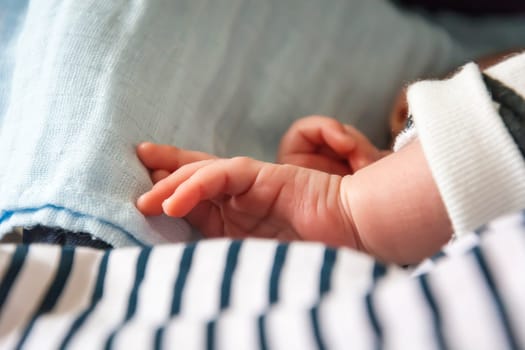 hand of a newborn child while sleeping peacefully