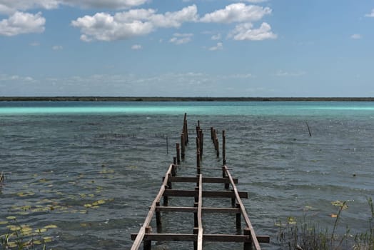Old broken pier at the lagoon of Bacalar, Quintana Roo, Mexico.