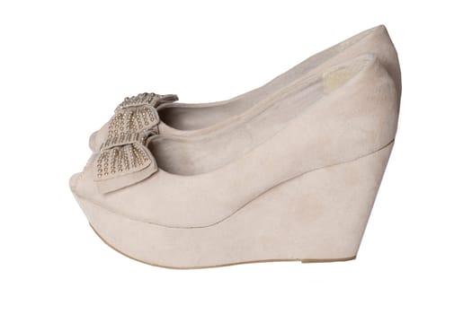 Shoe fashion. A pair of beige denim womens suede high heels shoes isolated on a white background.
