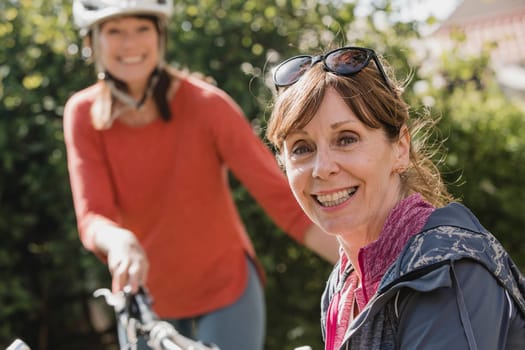 Headshot of a senior female cyclist looking at the camera and smiling.
