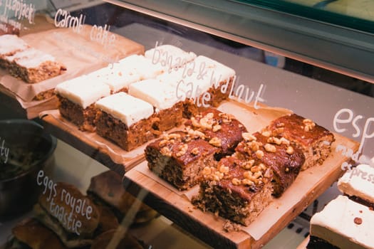 Selection of cakes in a coffee shops display unit.