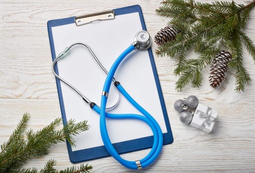 Stethoscope, blank clipboard and Christmas decorations. Medical concept. Greeting card. New Year and Christmas.