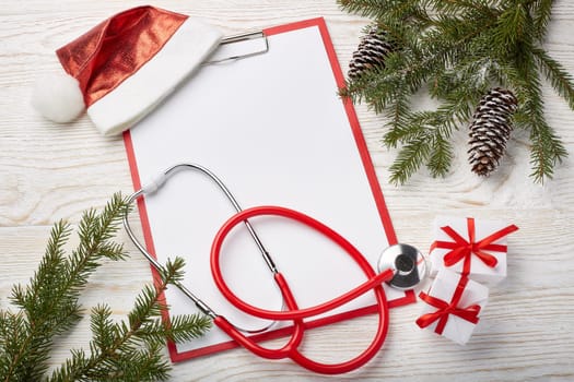 Stethoscope, blank clipboard and Christmas decorations. Medical concept. Greeting card. New Year and Christmas.