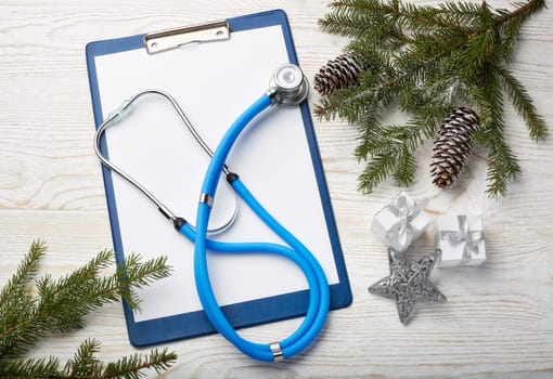 Stethoscope, blank clipboard and Christmas decorations. Medical concept. Greeting card. New Year and Christmas.