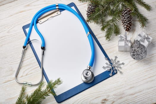 Stethoscope, blank clipboard and Christmas decorations. Medical concept. Greeting card. New Year and Christmas.