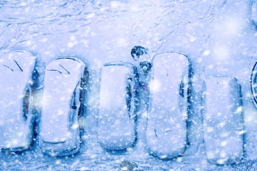 Elevated view of children play in snow covered parking lot