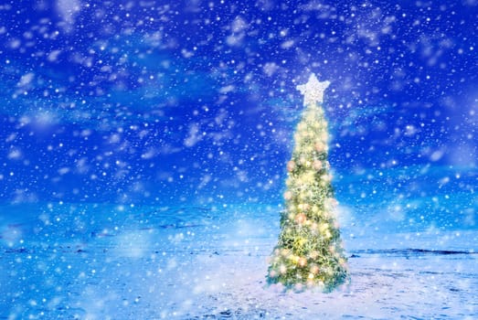 Conceptual image of decorated Christmas tree with colorful lights and ornaments on snow covered landscape