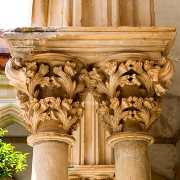 Detail of the Romanesque capitals depicting vegetal motifs on top of the columns in the Cemetery Cloister, in Tomar, Portugal