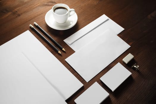 Photo of blank corporate stationery on wooden background. Branding mock-up.