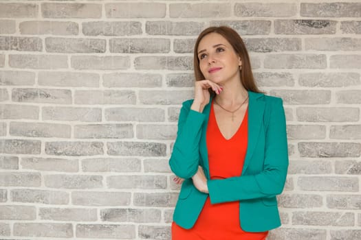 Portrait of a pensive woman looking away with hand on her chin