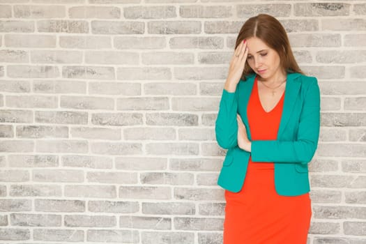 Young woman with headache, holding head, sad, sad brooding