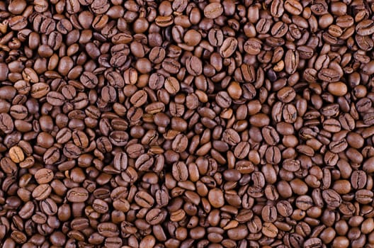 Background of coffee beans. Dropped brown coffee beans.
