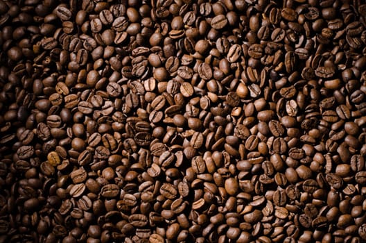 Background of coffee beans. Dropped brown coffee beans.