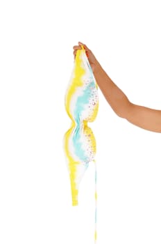A close up image of the arm of a woman holding a bra from a bikini, .isolated for white background.