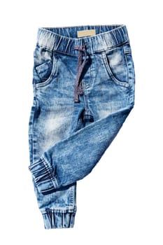 Blue jeans trousers isolated on white background. Fashionable jeans for child boy. Left trouser leg folded. Top view front.