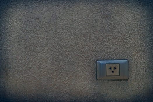 Electric plug socket built in old wall.