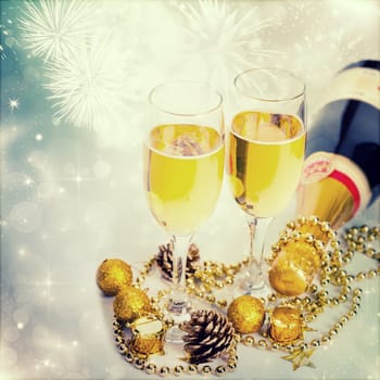 Glasses of champagne on sparkling holiday background with fireworks