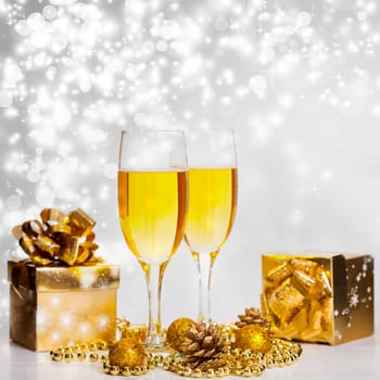 Glasses of champagne on sparkling holiday background with fireworks