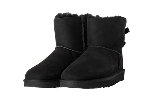 Winter boots. A pair black suede leather winter boots and lined with fur.  Isolated on a white background. Shoe fashion new collection winter 2018 to 2019.