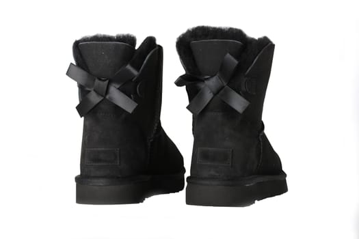 Winter boots. A pair black suede leather winter boots and lined with fur.  Isolated on a white background. Shoe fashion new collection winter 2018 to 2019.
