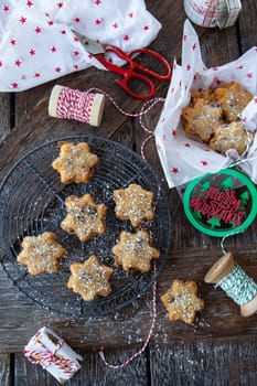 Traditional Christmas cookies with raisins on a rustic wooden background
