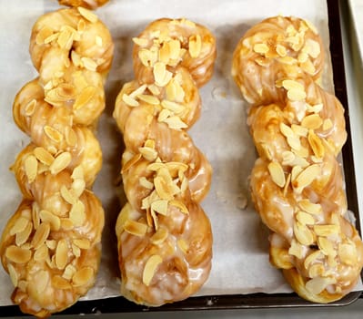 Delicious cakes with cream pigtail on the tray