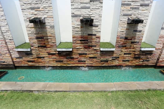 Beautiful wall is covered with multi-colored tiles