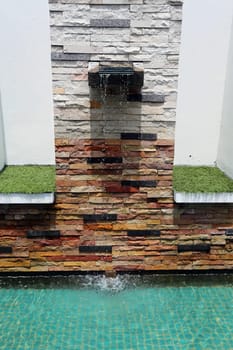 Beautiful wall is covered with multi-colored tiles