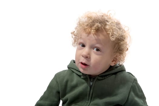 portrait of a little boy of 3 years with a green coat on white background