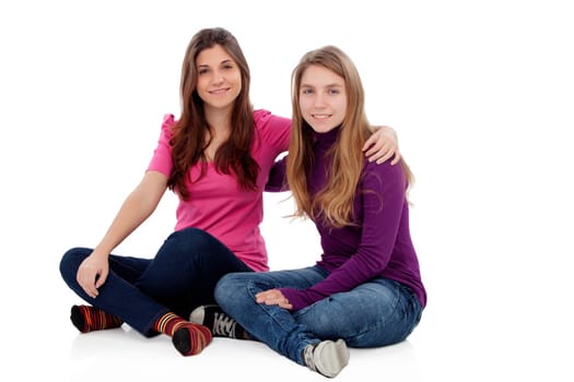 Two different sisters sitting on the floor isolated on a white background