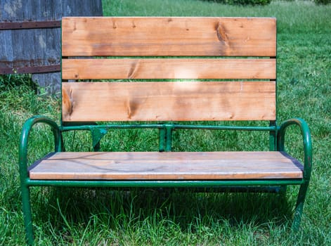 an old wooden bench in a green meadow. Free day and vacation concept