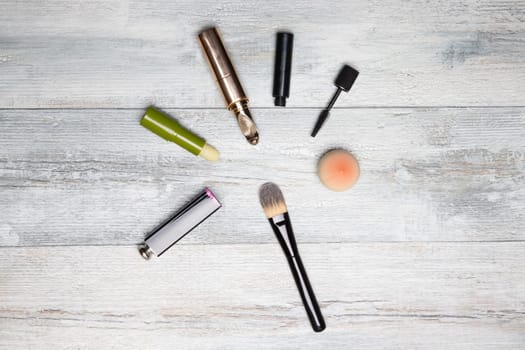 Cosmetic makeup set. Decorative compostion of cosmetics on rustic bright wooden table. Woman accessories on background with copy space.
