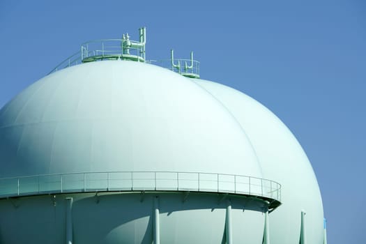 Sphere gas tanks in petrochemical plant against a blue sky