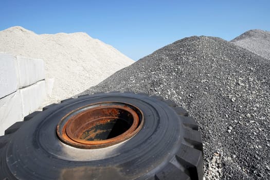 Large mound of crushed stone granite against the blue sky