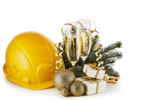 Construction hard hat, fir tree branches, two glasses with champange and Christmas ornament isolated on a white background. New Year and Christmas. Horizontal view