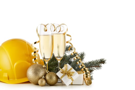 Construction hard hat, fir tree branches, two glasses with champange and Christmas ornament isolated on a white background. New Year and Christmas. Horizontal view