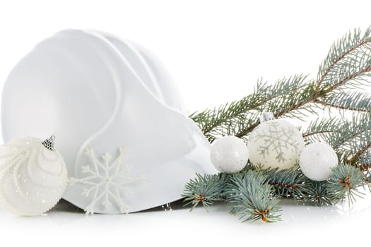 Construction hard hat, fir tree branches and Christmas ornament isolated on a white background. New Year and Christmas. Horizontal view.