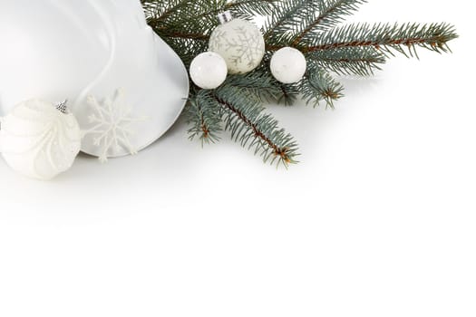 Construction hard hat, fir tree branches and Christmas ornament isolated on a white background. New Year and Christmas. Top view with copy space